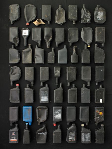 Motor oil black plastic bottles on black background