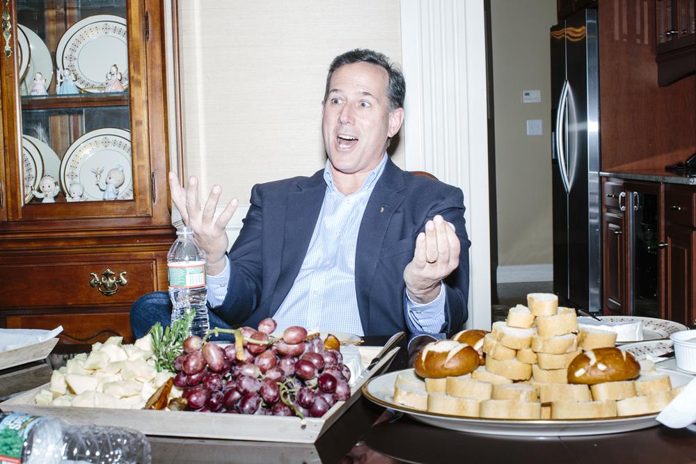 Former Pennsylvania senator and Republican presidential candidate Rick Santorum talks with guests at a party at the home of Carem Bennett in Bedford, New Hampshire. There were eleven people at the gathering, including Bennett, her husband, and their two children. The group chatted about the campaign process and Santorum's position on domestic and international issues.