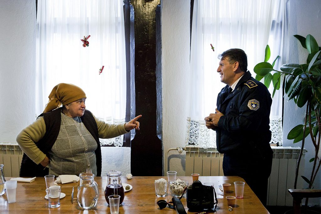 Old woman, resident of the city of Djakovica, speaks with the commander of Kosovo police for the district of Decani in the guestroom of monastery Visoki Decani. She and three other women are the only remaining Serbian resident of the nearby town of Djakovica in Kosovo. Before the war, number of residents of Djakovica who were Serbs was 12.000. The lady said that this commander took very good care about remaining Serbs.